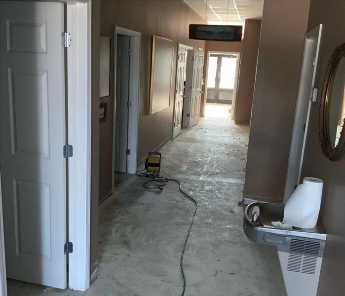 image of commercial building hallway with water damage before 3 foot flood cuts are made