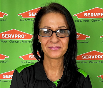 female sitting in front of SERVPRO backdrop
