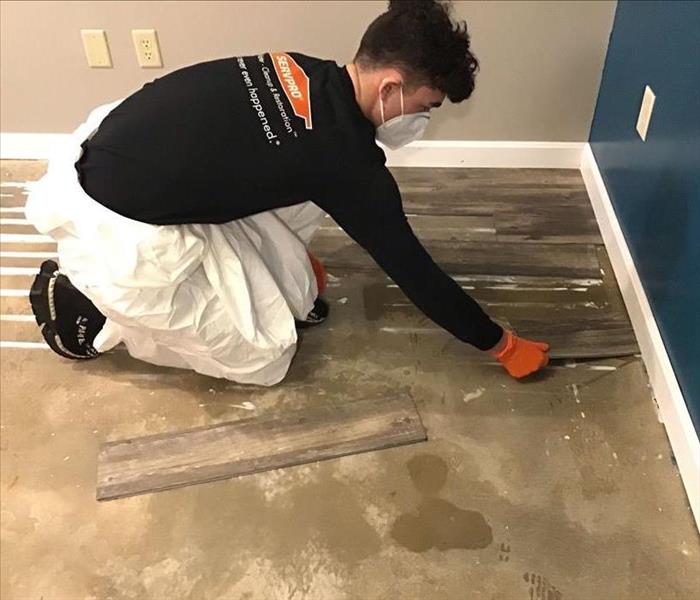 SERVPRO team member removing flooring.